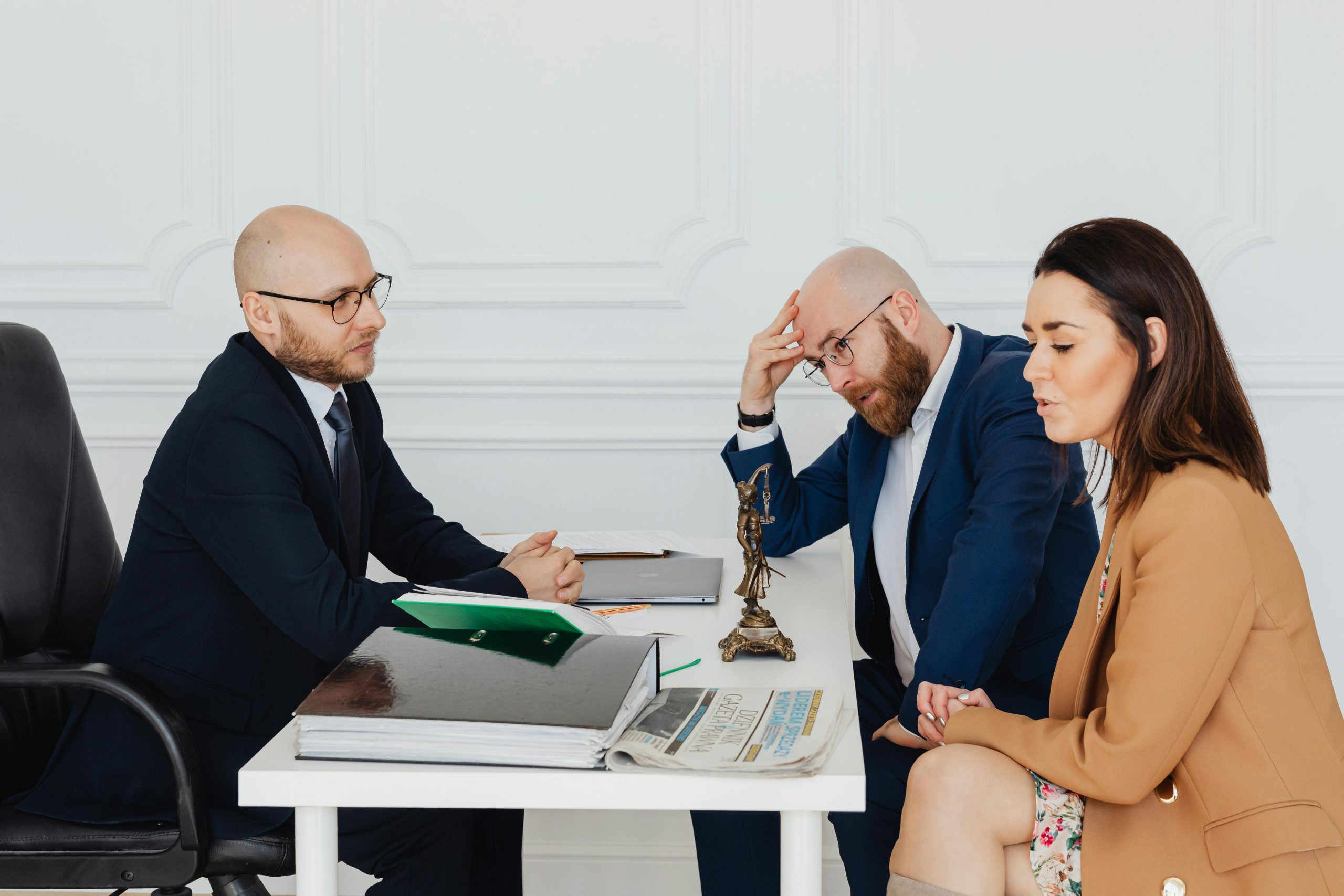 divorcing couple sitting with a divorce mediator
