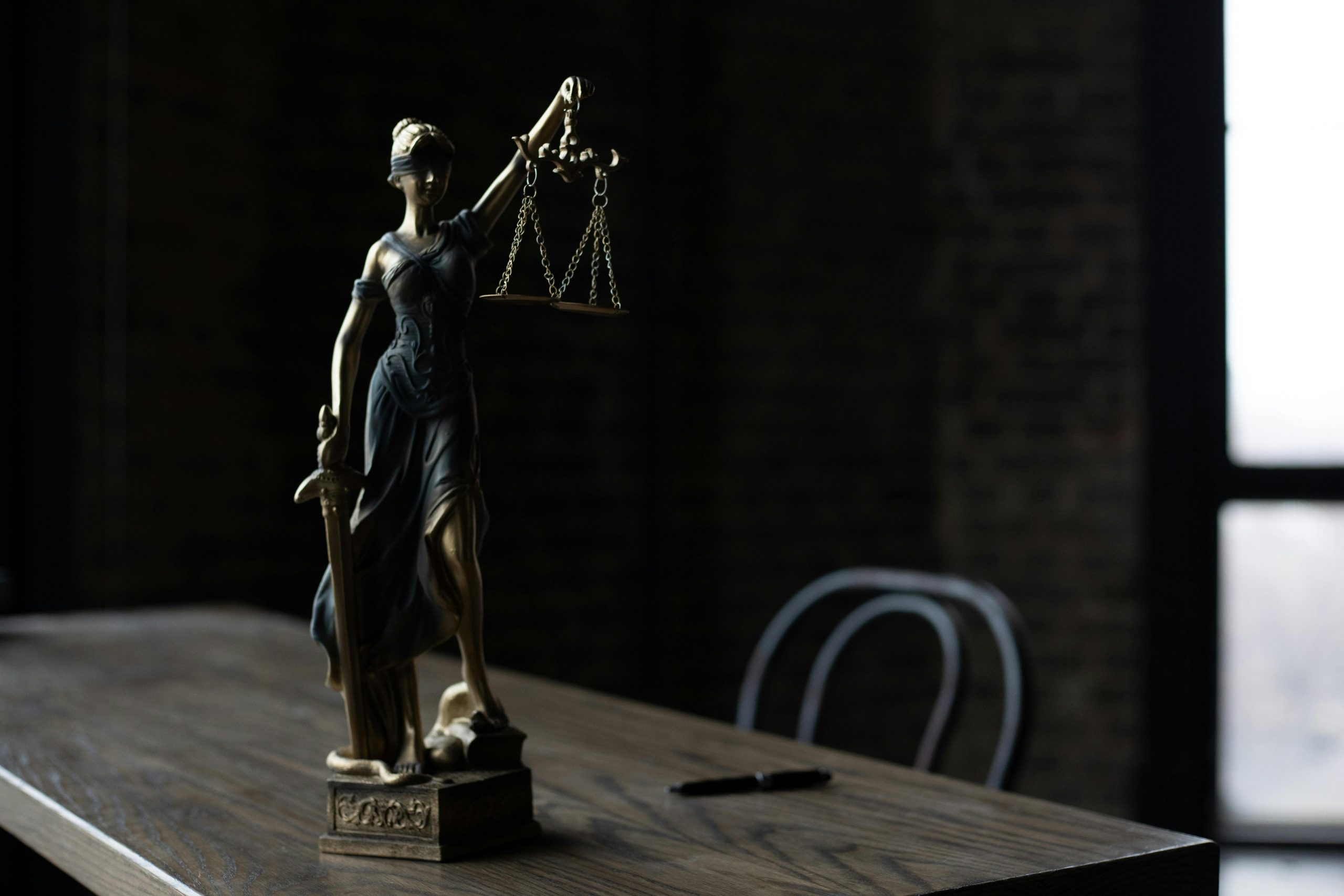 Lady Justice figurine on a wooden table