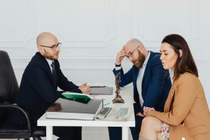 divorcing couple sitting with a divorce mediator