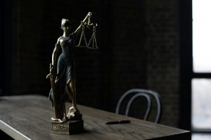 Lady Justice figurine on a wooden table