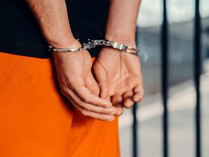 close-up shot of a prisoner's cuffed hands
