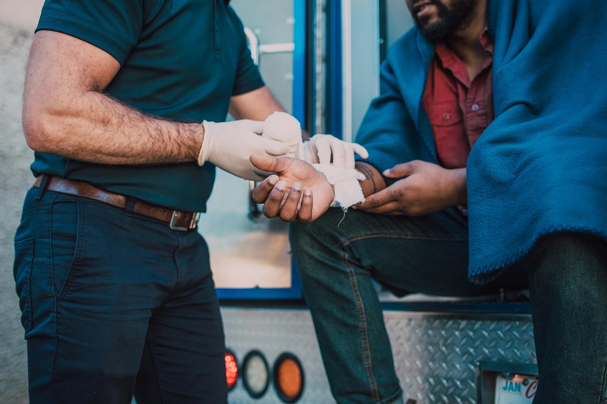 paramedic treating an injured man's wrist